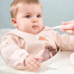 Done By Deer Sleeved Pocket Bib - Playground - Powder 11 Done By Deer Sleeved Pocket Bib - Playground - Powder -Done By Deer Sleeved pocket bib Playground Powder LS