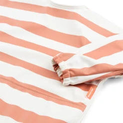 Done By Deer Sleeved Pocket Bib - Stripes - Papaya 8 Done By Deer Sleeved Pocket Bib - Stripes - Papaya -Done By Deer Sleeved pocket bib Stripes Papaya Detail 2 PS 1